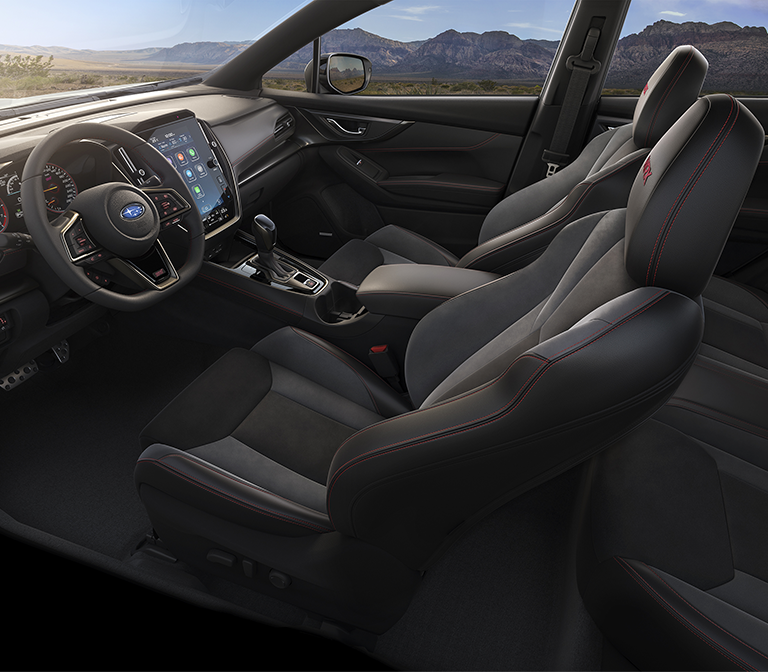 Interior de Subaru WRX mostrando asientos delanteros, volante y tablero.